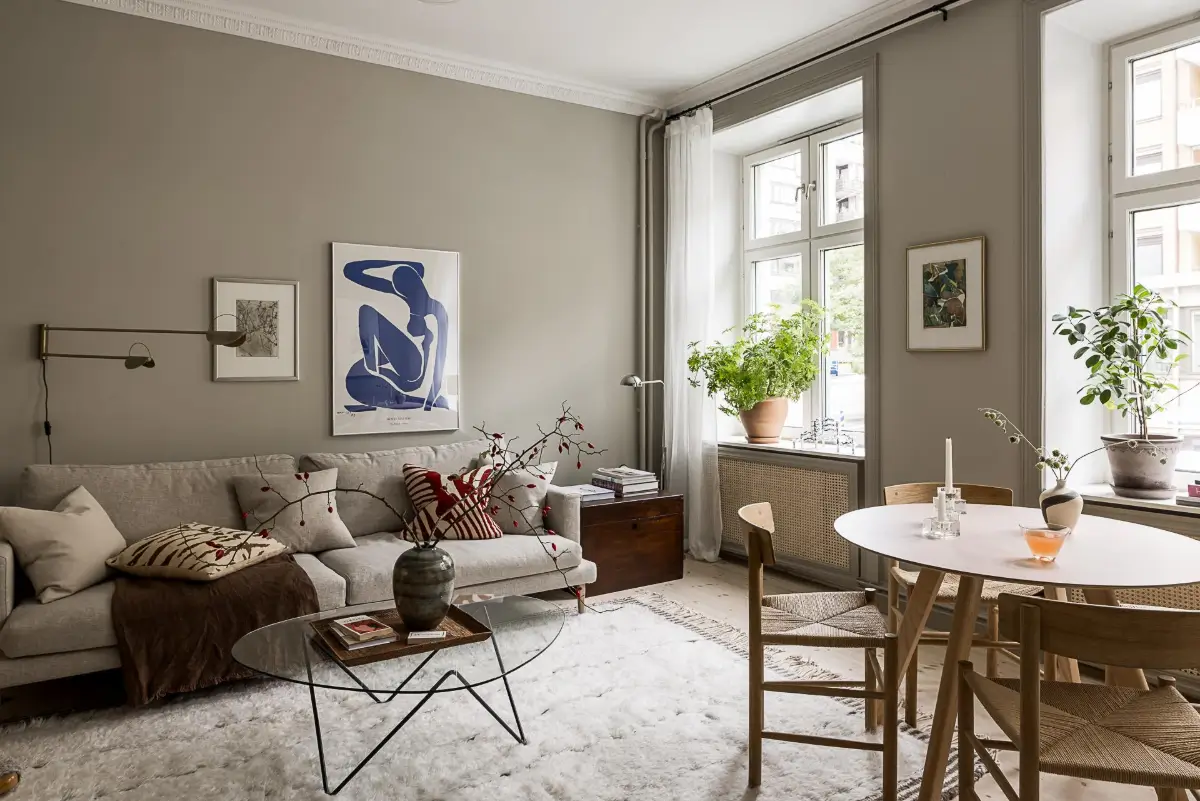 Gray Tones, Wallpapers, and a Mint Green Fireplace in a Swedish Apartment 2 scandinavian living room gray walls large rug round table