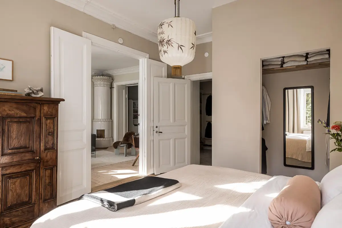 Warm Neutral Tones and Period Features in a Swedish Apartment 16 serene bedroom walk-in wardrobe