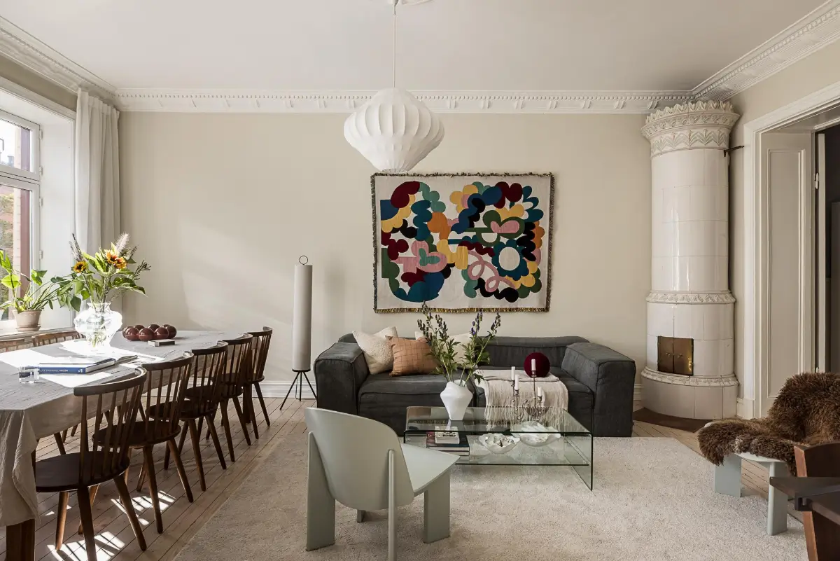 Warm Neutral Tones and Period Features in a Swedish Apartment 6 serene living room large table stucco fireplace