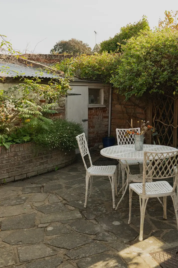 A Charming English Cottage with a Sage-Green Kitchen 14 small paved cottage garden