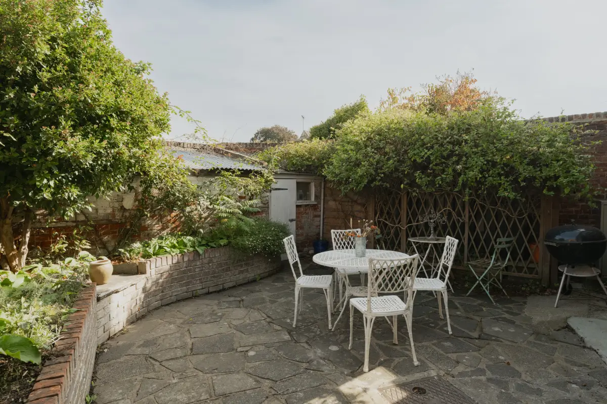 A Charming English Cottage with a Sage-Green Kitchen 22 small paved garden