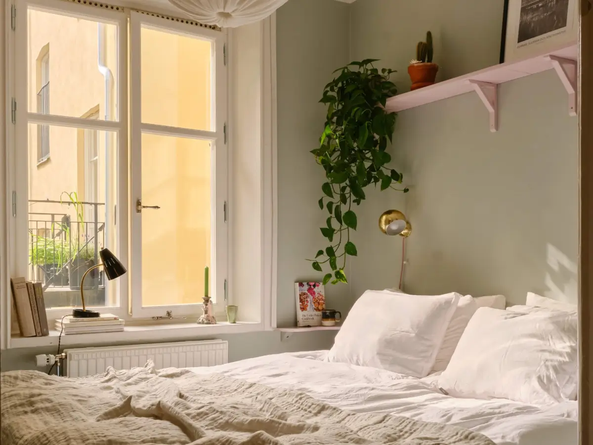 Green and Apricot Rooms in a Charming Stockholm Apartment 21 tiny bedroom pink wooden shelf