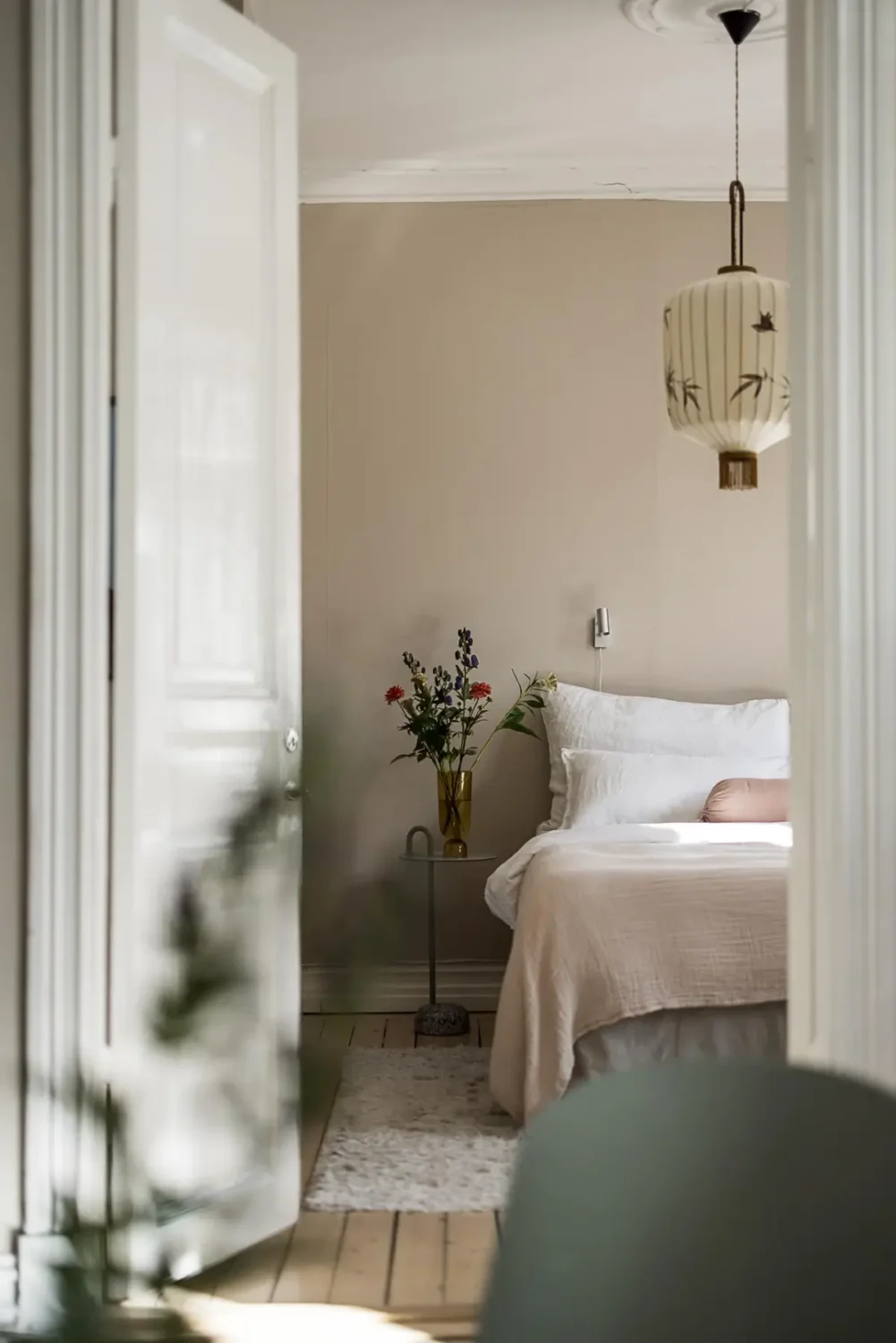 Warm Neutral Tones and Period Features in a Swedish Apartment 12 view into bedroom