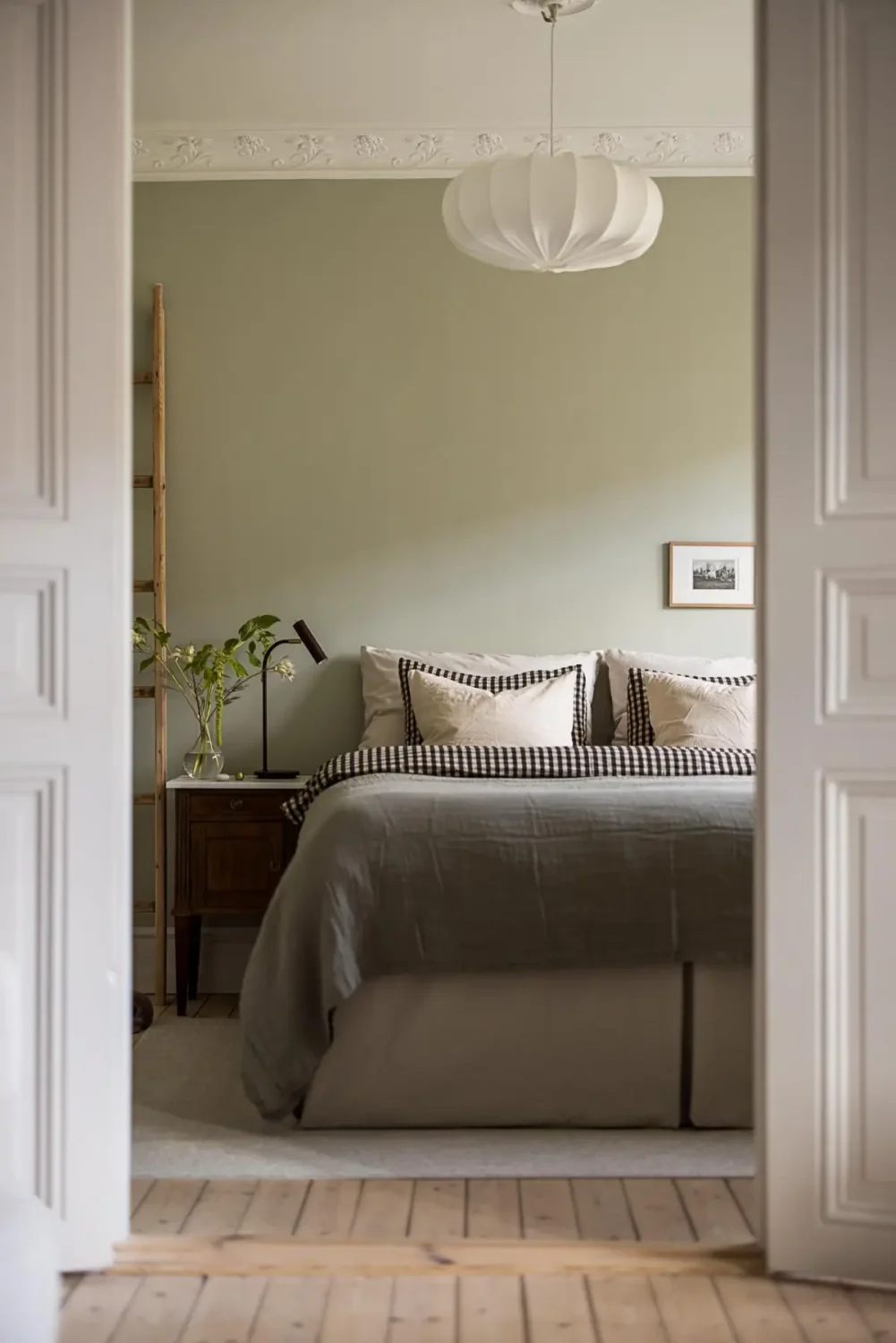 A Classic Renovated Apartment with a Social Light Green Kitchen 12 view into bedroom