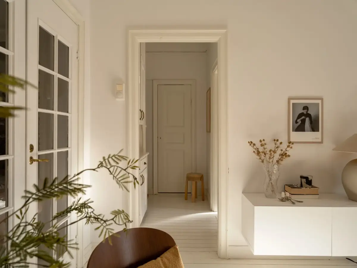 A Fresh 1920s Apartment with White Floorboards and Exposed Brick 19 view into hall