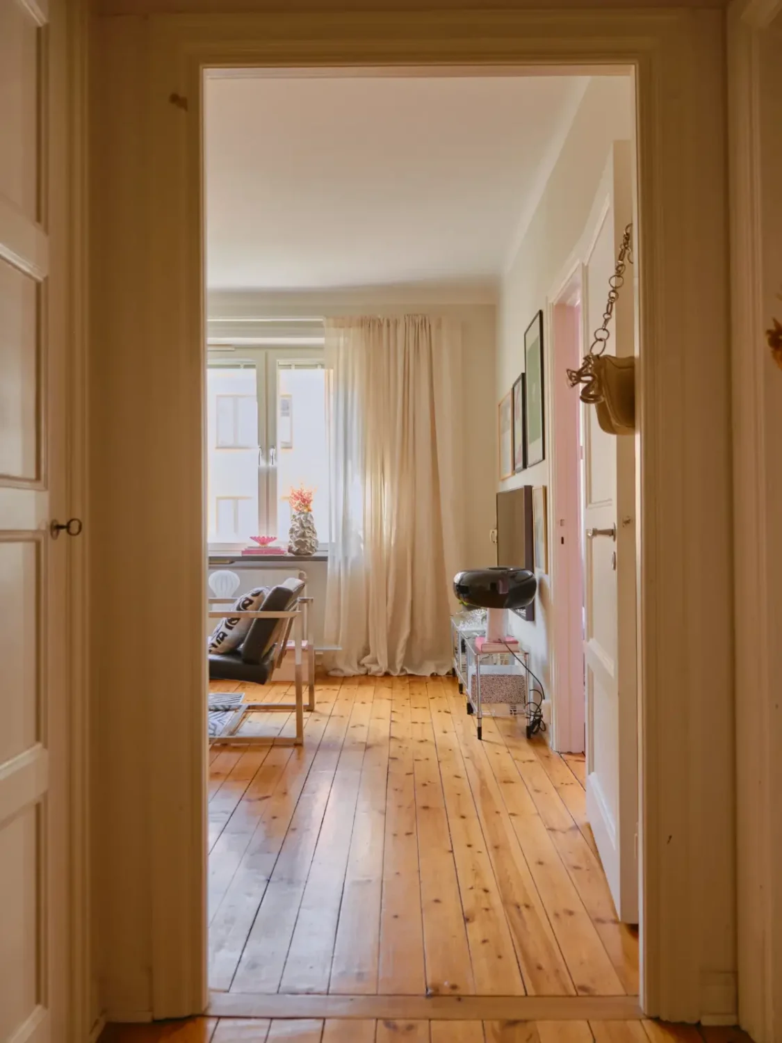 A Light 1930s Apartment with a Bubblegum Pink Bedroom 13 view into living room