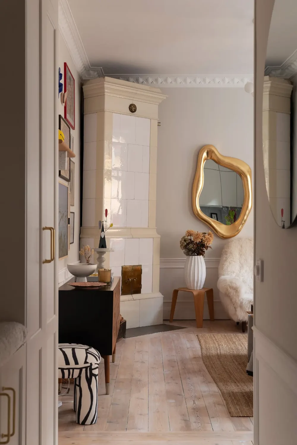 Neutral Tones and Period Character from the 1910s in a Stockholm Apartment 10 view into living room with fireplace