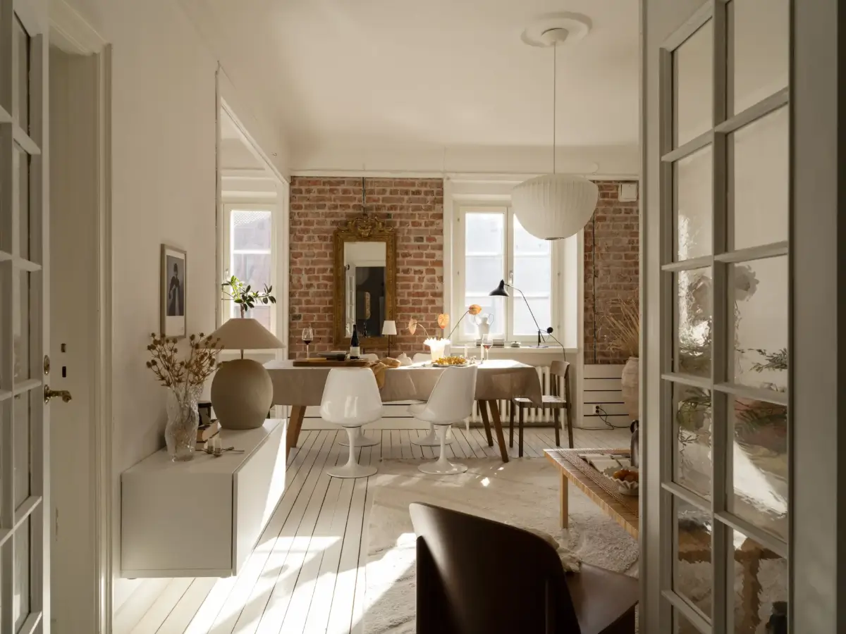 A Fresh 1920s Apartment with White Floorboards and Exposed Brick 14 white floorboards living room brick wall