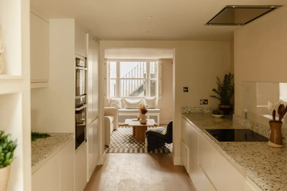 A Serene Duplex Apartment with a Glass Extension in London 20 white galley kitchen terrazzo countertop