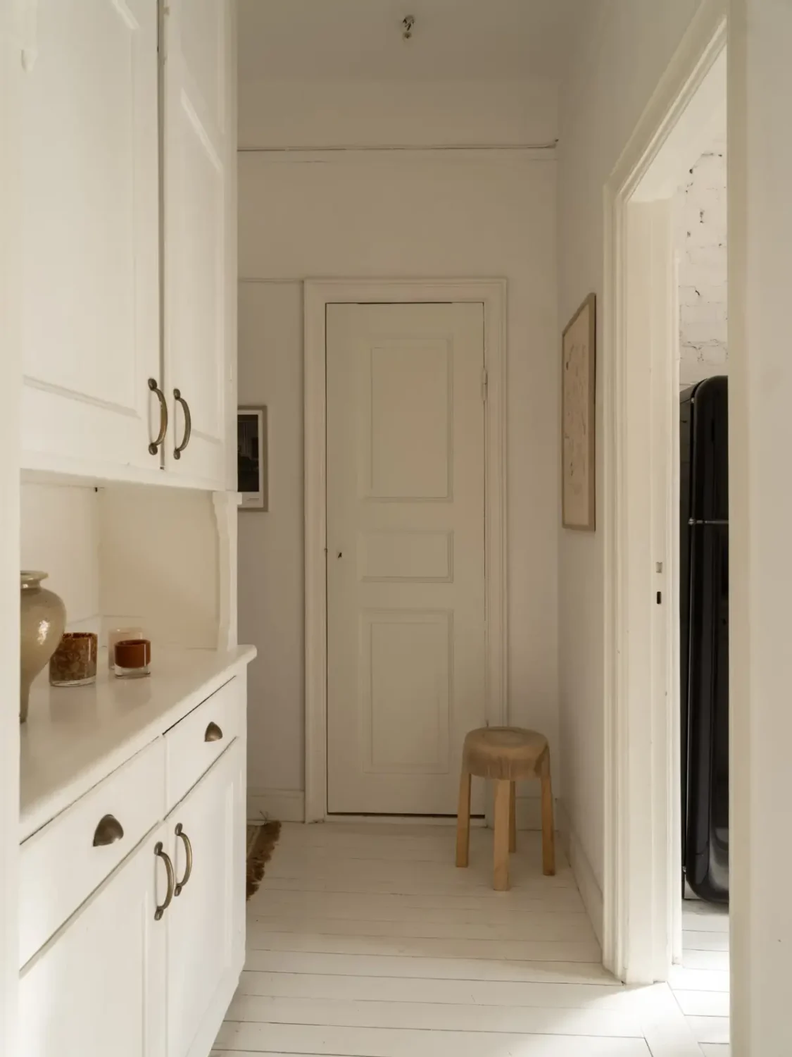 A Fresh 1920s Apartment with White Floorboards and Exposed Brick 20 white hall original built-in cabinets
