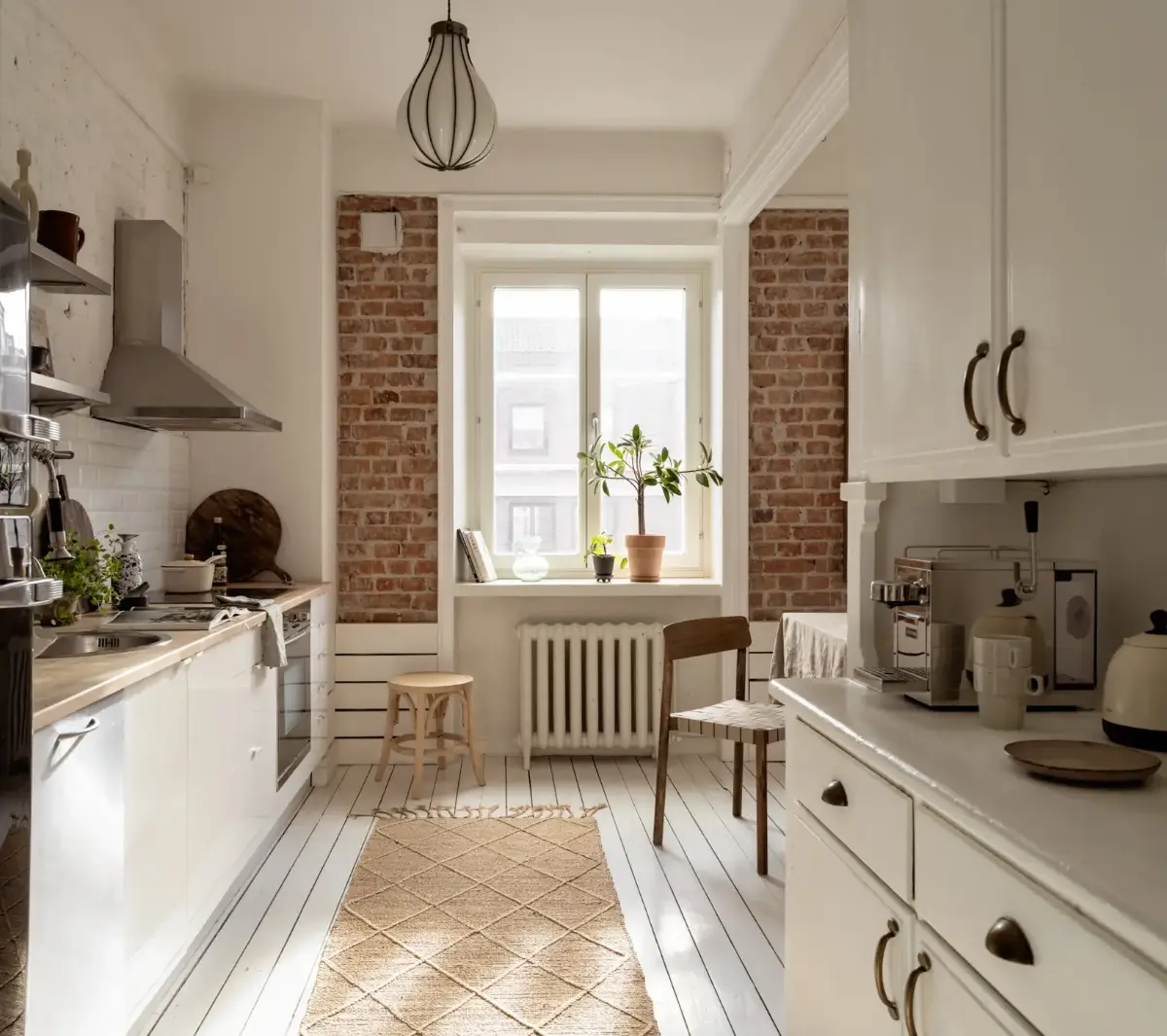 A Fresh 1920s Apartment with White Floorboards and Exposed Brick 10 white kitchen exposed brick wall