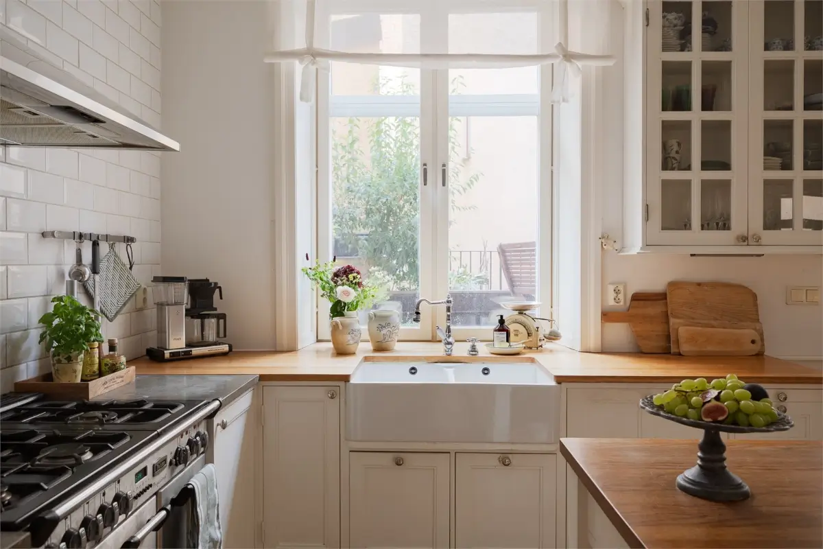 A Light-Filled Stockholm Apartment with a Charming Kitchen 3 white kitchen with butler sink