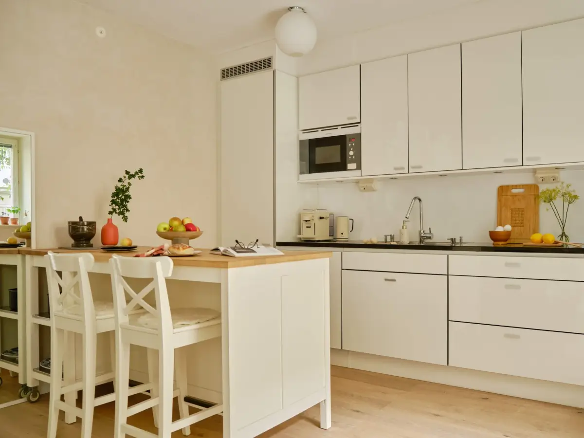 Former Stables Transformed into a Modern, Light House with Plaster Walls 6 white kitchen with island