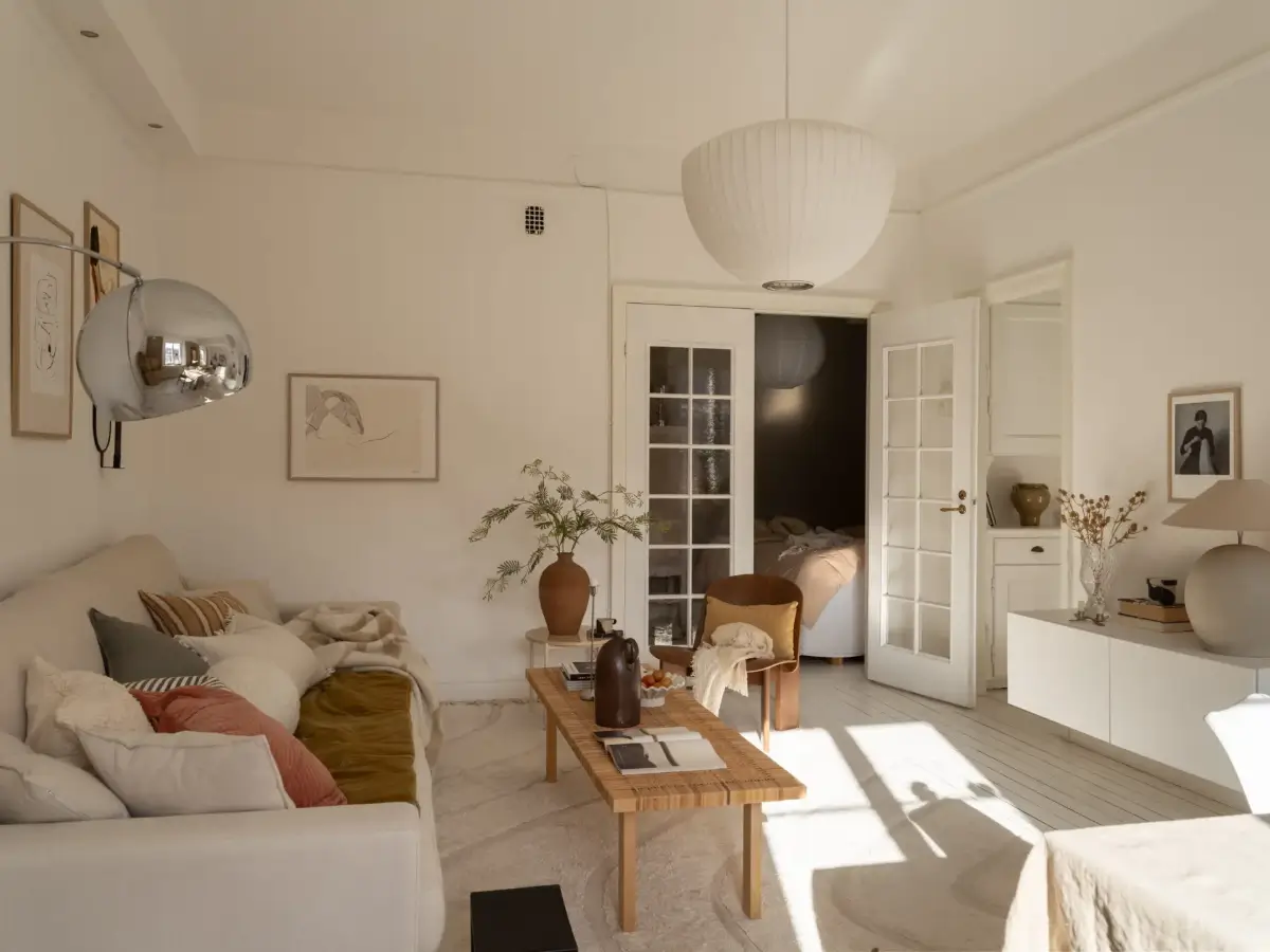 A Fresh 1920s Apartment with White Floorboards and Exposed Brick 13 white living room glass doors
