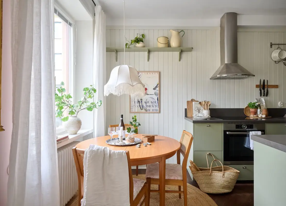 green kitchen round table paneled walls