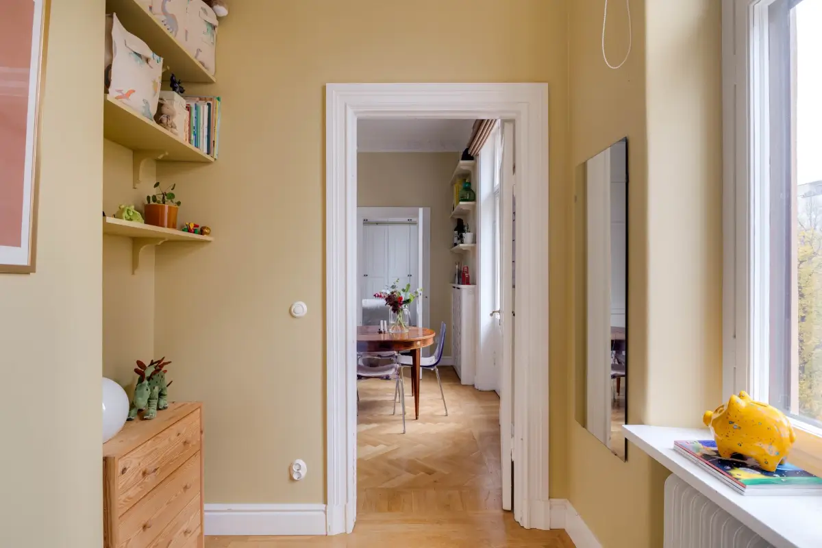 Classic Elements and Modern Comforts in an Elegant Apartment 9 ochre nursery built-in shelves