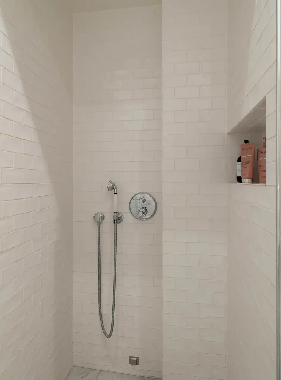 Classic Elements and Modern Comforts in an Elegant Apartment 13 white tiled shower with niche