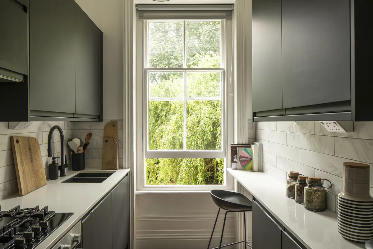 Small Space, Big Style: How to Design a Teeny-Tiny Kitchen That Works 25 tiny kitchen black cabinets small bar seating nordroom Small Space, Big Style: How to Design a Teeny-Tiny Kitchen That Works