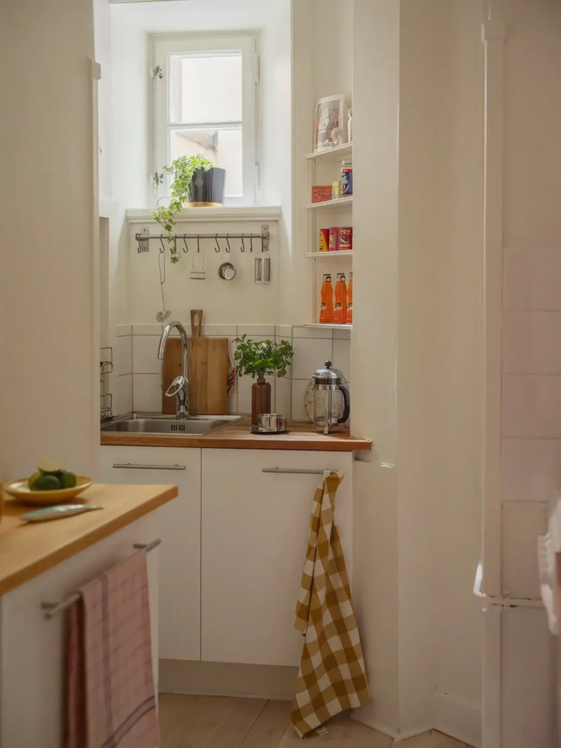 Small Space, Big Style: How to Design a Teeny-Tiny Kitchen That Works 35 tiny kitchen corner shelves handing rod nordroom Small Space, Big Style: How to Design a Teeny-Tiny Kitchen That Works