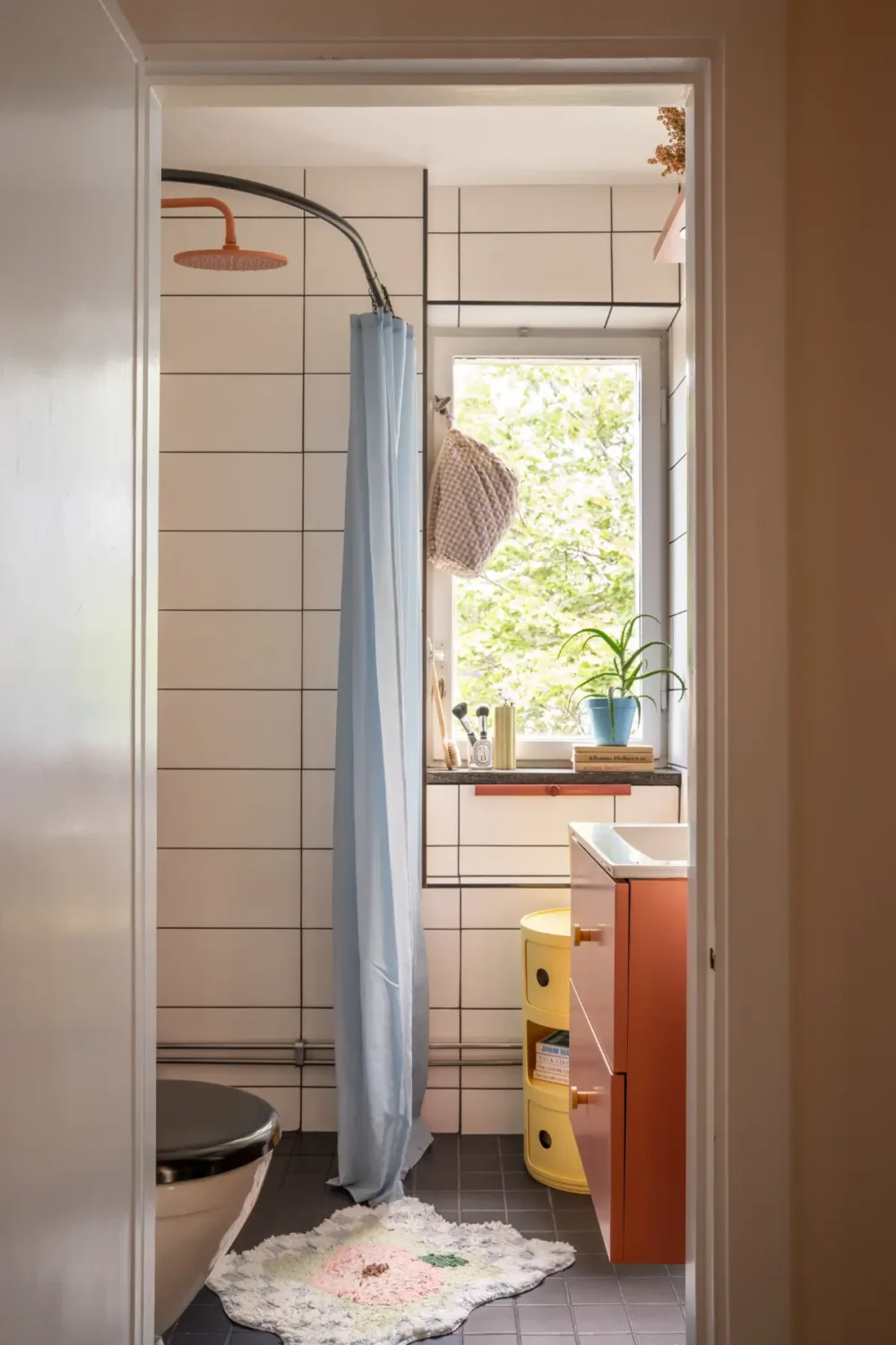 Cheerful Colors in a Small & Light 1940s Apartment in Stockholm 28 bathroom-pastel-blue-shower-curtain-terracotta-cabinet-nordroom
