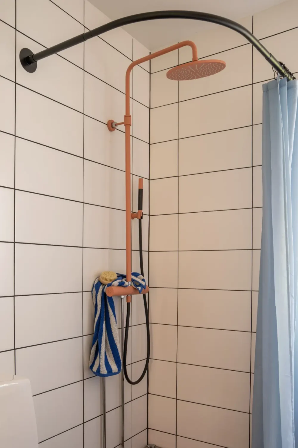 Cheerful Colors in a Small & Light 1940s Apartment in Stockholm 29 bathroom-pink-shower-head-nordroom