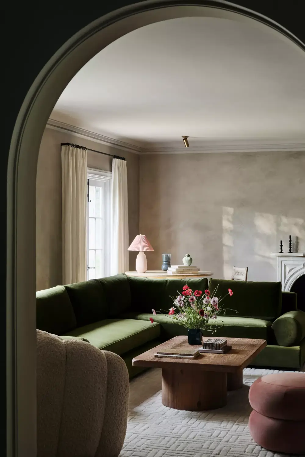 The 2027 Color of the Year Prediction: A Shift Toward More Expressive Colors? 18 living room green corner sofa arched doorway The 2027 Color of the Year Prediction: A Shift Toward More Expressive Colors?