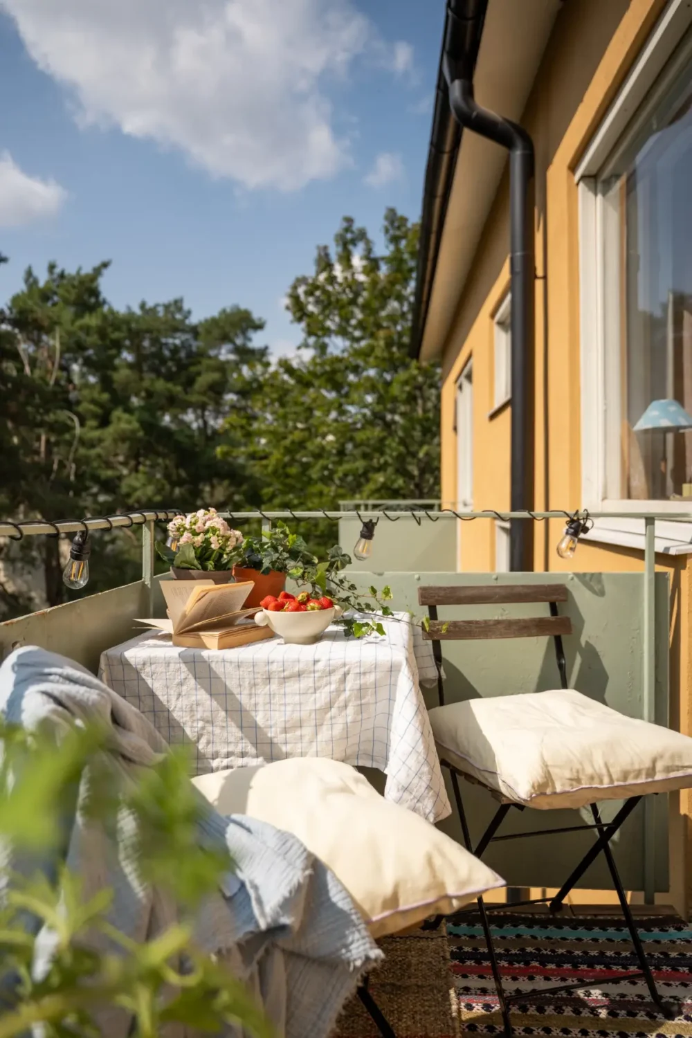 Cheerful Colors in a Small & Light 1940s Apartment in Stockholm 4 sunny balcony with small table nordroom