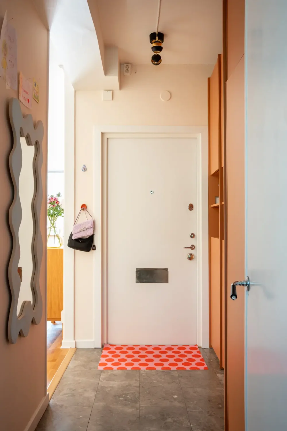Cheerful Colors in a Small & Light 1940s Apartment in Stockholm 32 tiled-hall-terracotta-colored-storage-cabinets-dotted-doormat-nordroom