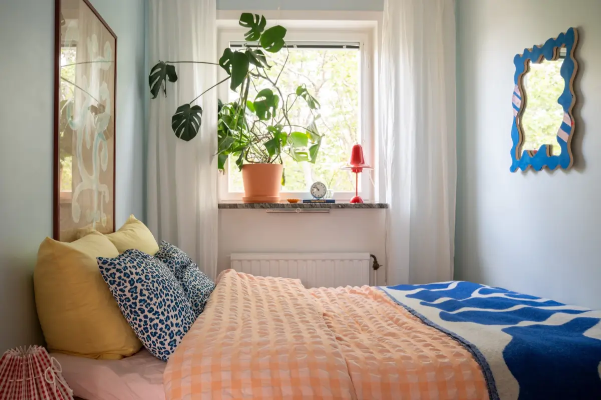 Cheerful Colors in a Small & Light 1940s Apartment in Stockholm 17 tiny bedroom blue-gray walls colorful textiles nordroom
