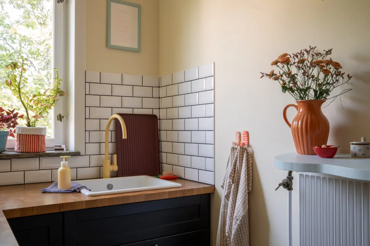 Cheerful Colors in a Small & Light 1940s Apartment in Stockholm 23 tiny-kitchen-yellow-faucet-white-tiles-nordroom