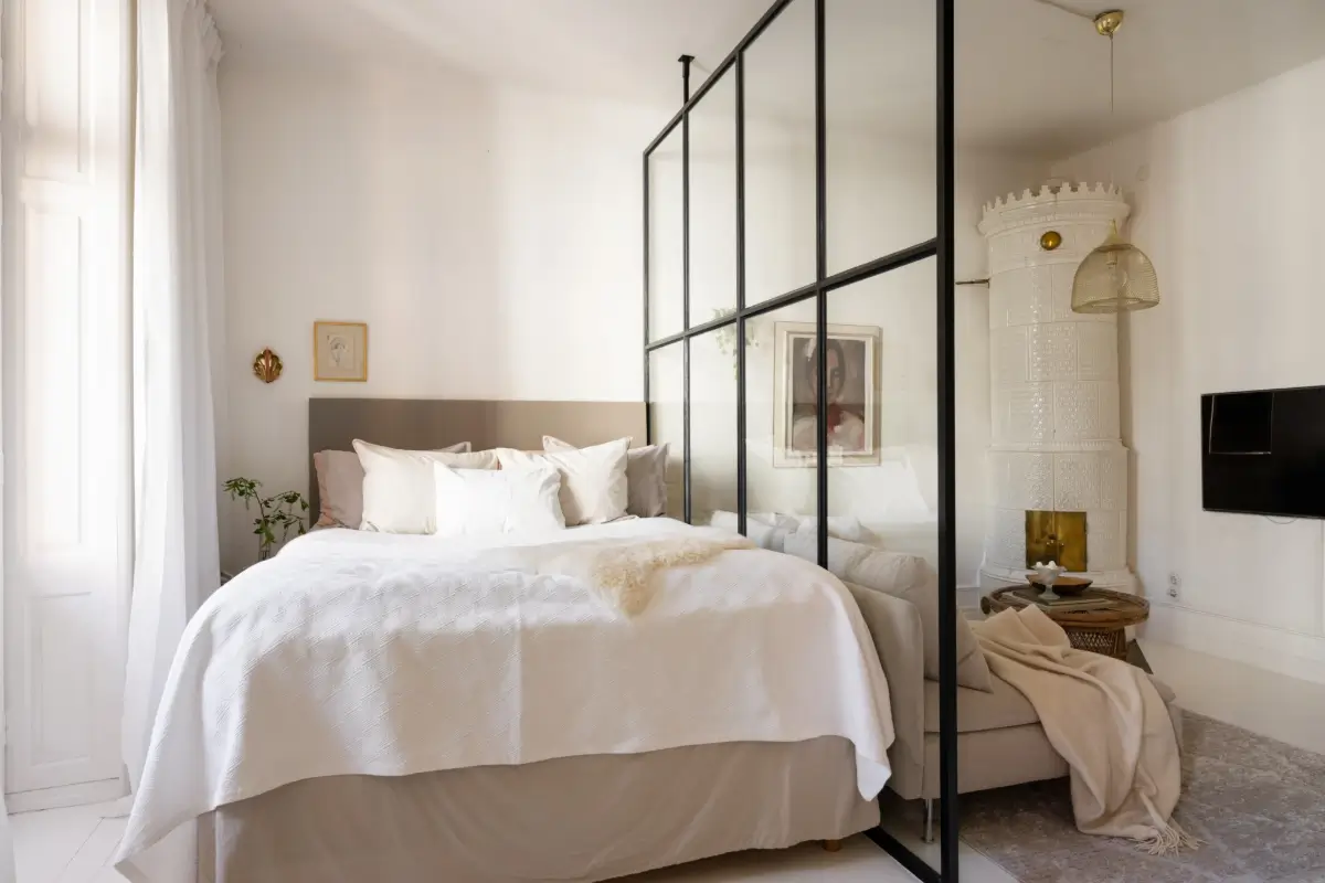 An Elegant Stockholm Apartment Blends Modern Elements with Period Features 20 bright-studio-apartment-industrial-glass-room-divider-lush-balcony