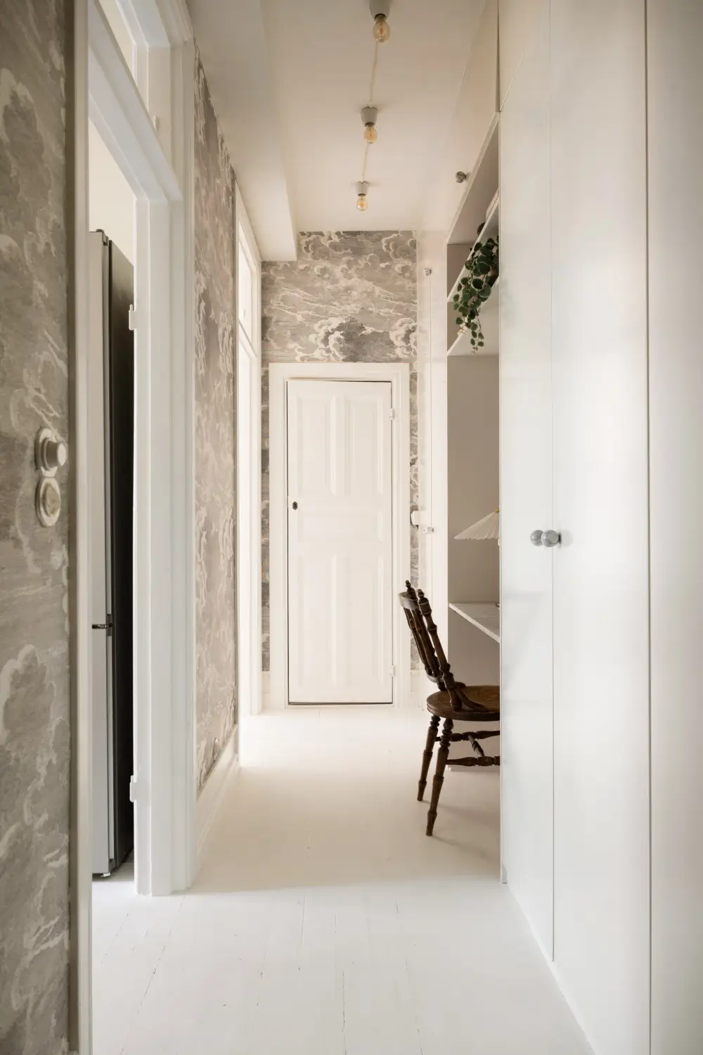 An Elegant Stockholm Apartment Blends Modern Elements with Period Features 28 bright-studio-apartment-industrial-glass-room-divider-lush-balcony