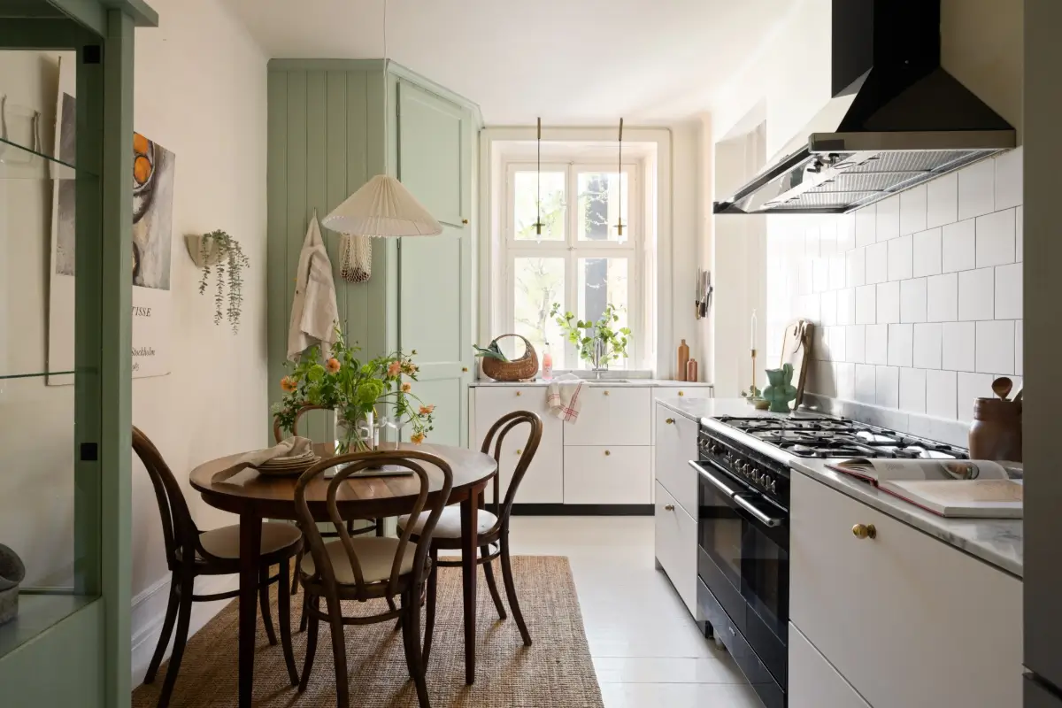 An Elegant Stockholm Apartment Blends Modern Elements with Period Features 1 bright-studio-apartment-industrial-glass-room-divider-lush-balcony