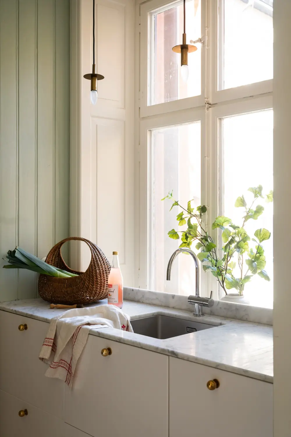 An Elegant Stockholm Apartment Blends Modern Elements with Period Features 5 bright-studio-apartment-industrial-glass-room-divider-lush-balcony