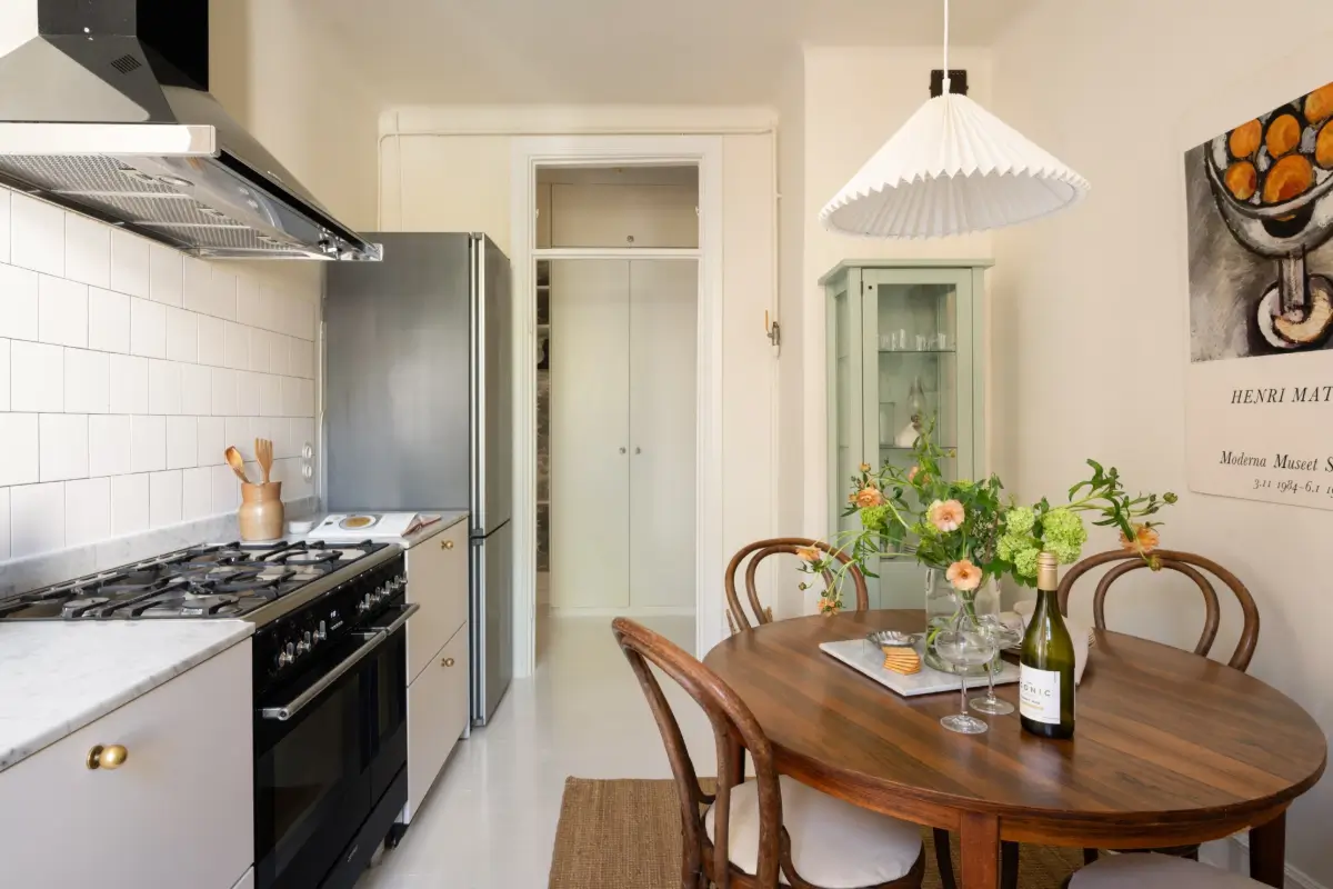An Elegant Stockholm Apartment Blends Modern Elements with Period Features 12 bright-studio-apartment-industrial-glass-room-divider-lush-balcony