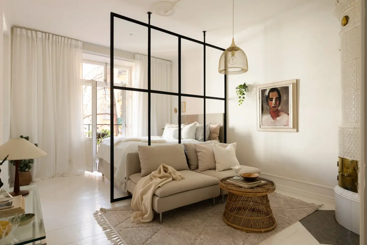 An Elegant Stockholm Apartment Blends Modern Elements with Period Features 13 bright-studio-apartment-industrial-glass-room-divider-lush-balcony
