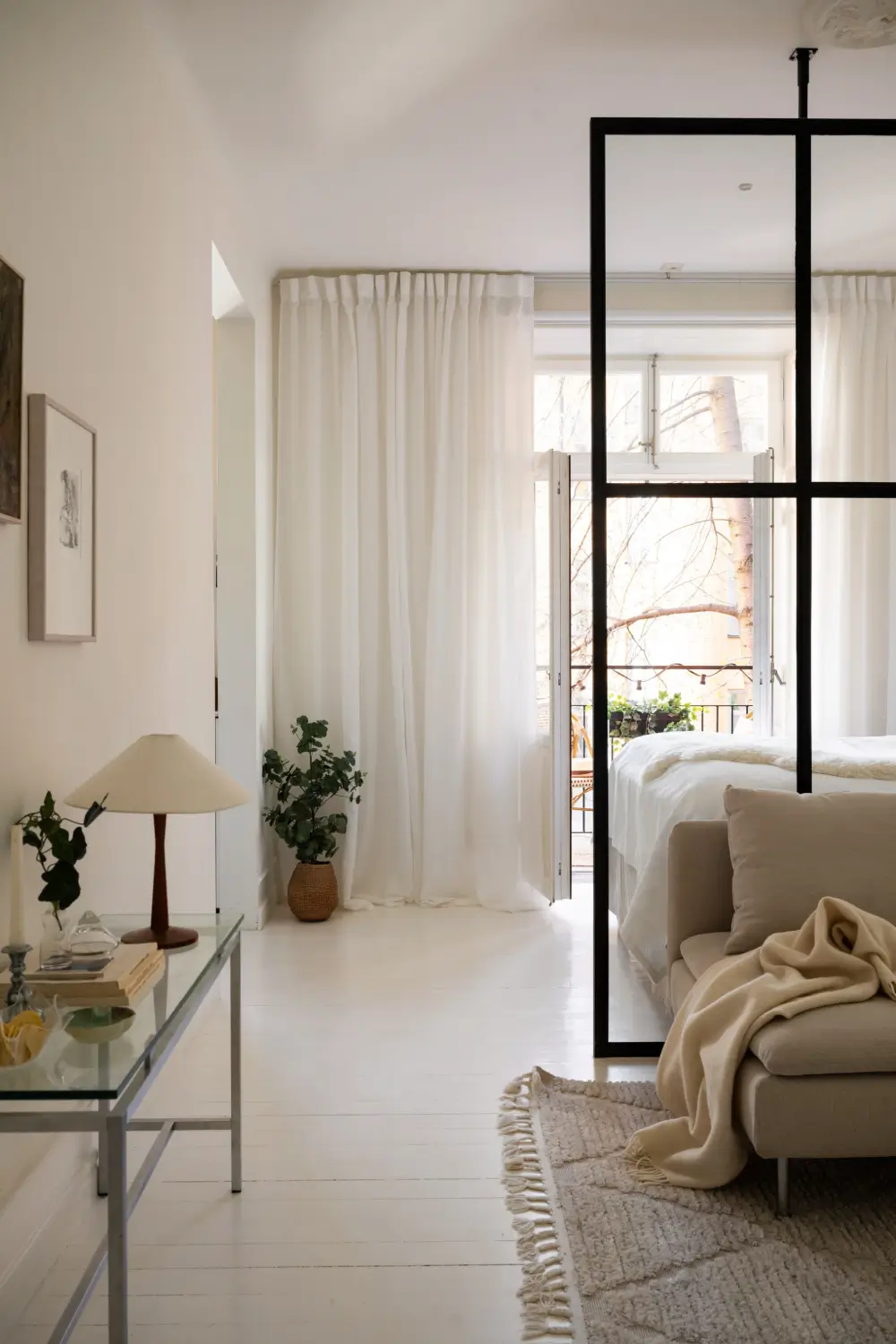 An Elegant Stockholm Apartment Blends Modern Elements with Period Features 14 bright-studio-apartment-industrial-glass-room-divider-lush-balcony