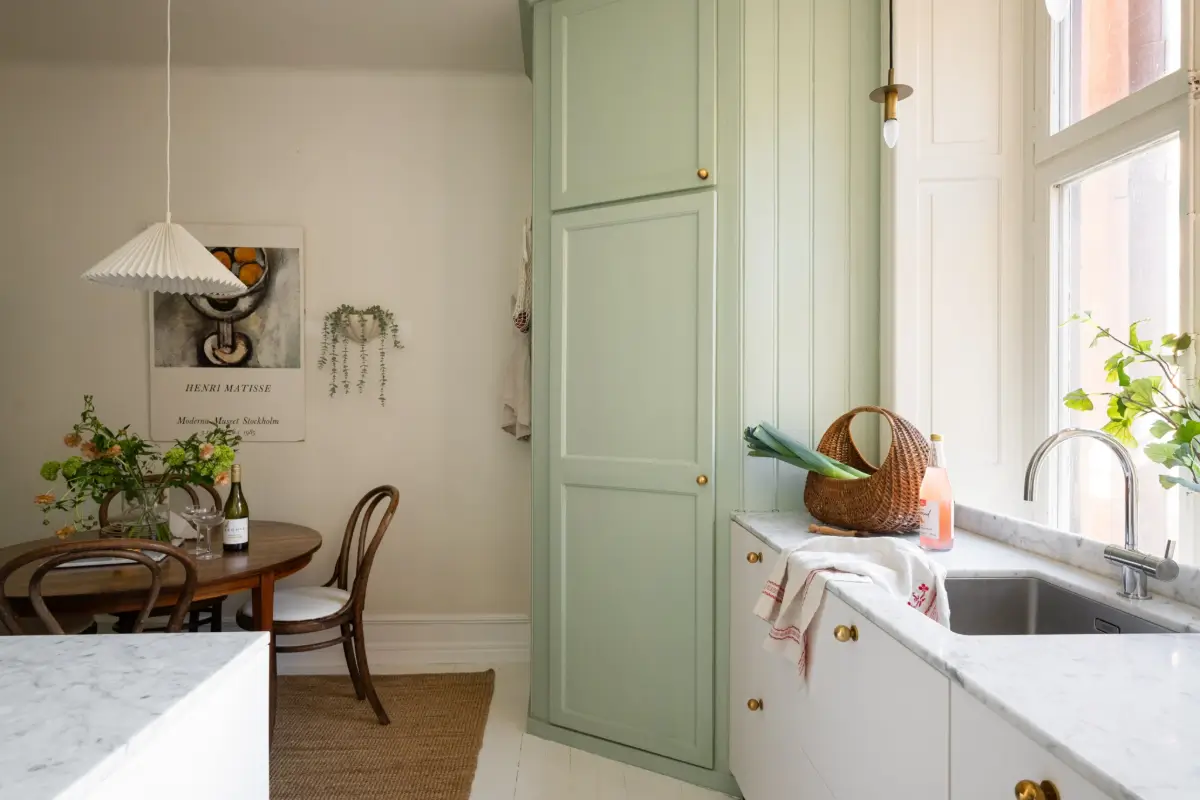 An Elegant Stockholm Apartment Blends Modern Elements with Period Features 4 bright-studio-apartment-industrial-glass-room-divider-lush-balcony