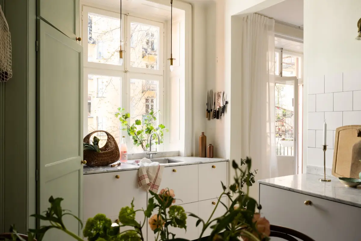 An Elegant Stockholm Apartment Blends Modern Elements with Period Features 8 bright-studio-apartment-industrial-glass-room-divider-lush-balcony