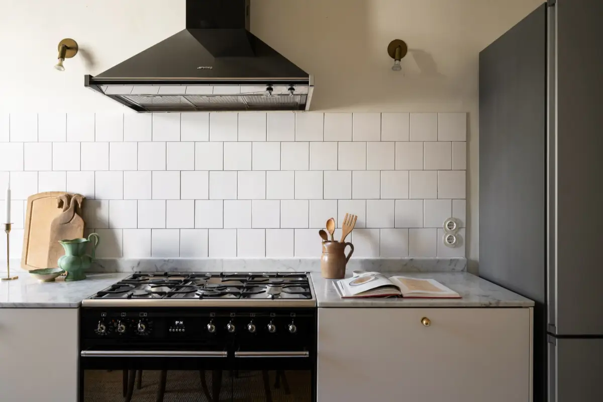 An Elegant Stockholm Apartment Blends Modern Elements with Period Features 9 bright-studio-apartment-industrial-glass-room-divider-lush-balcony