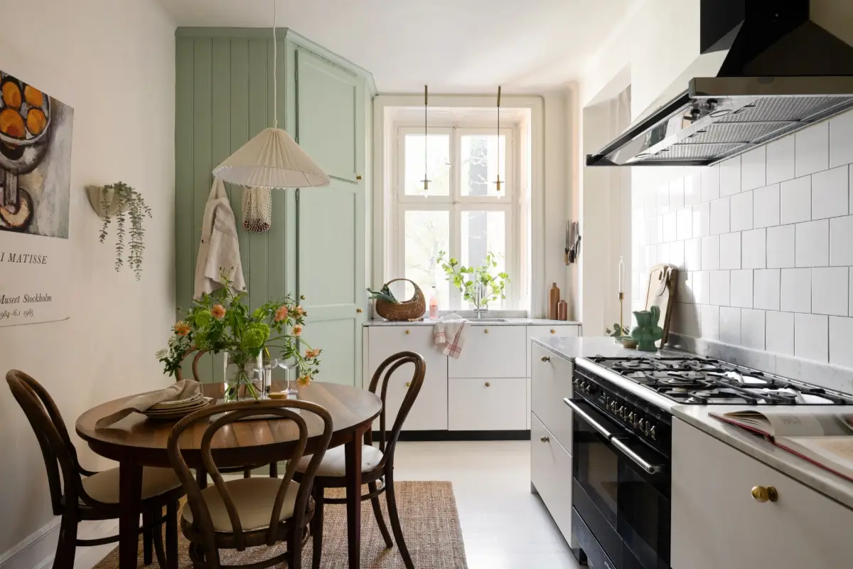 An Elegant Stockholm Apartment Blends Modern Elements with Period Features 7 bright-studio-apartment-industrial-glass-room-divider-lush-balcony