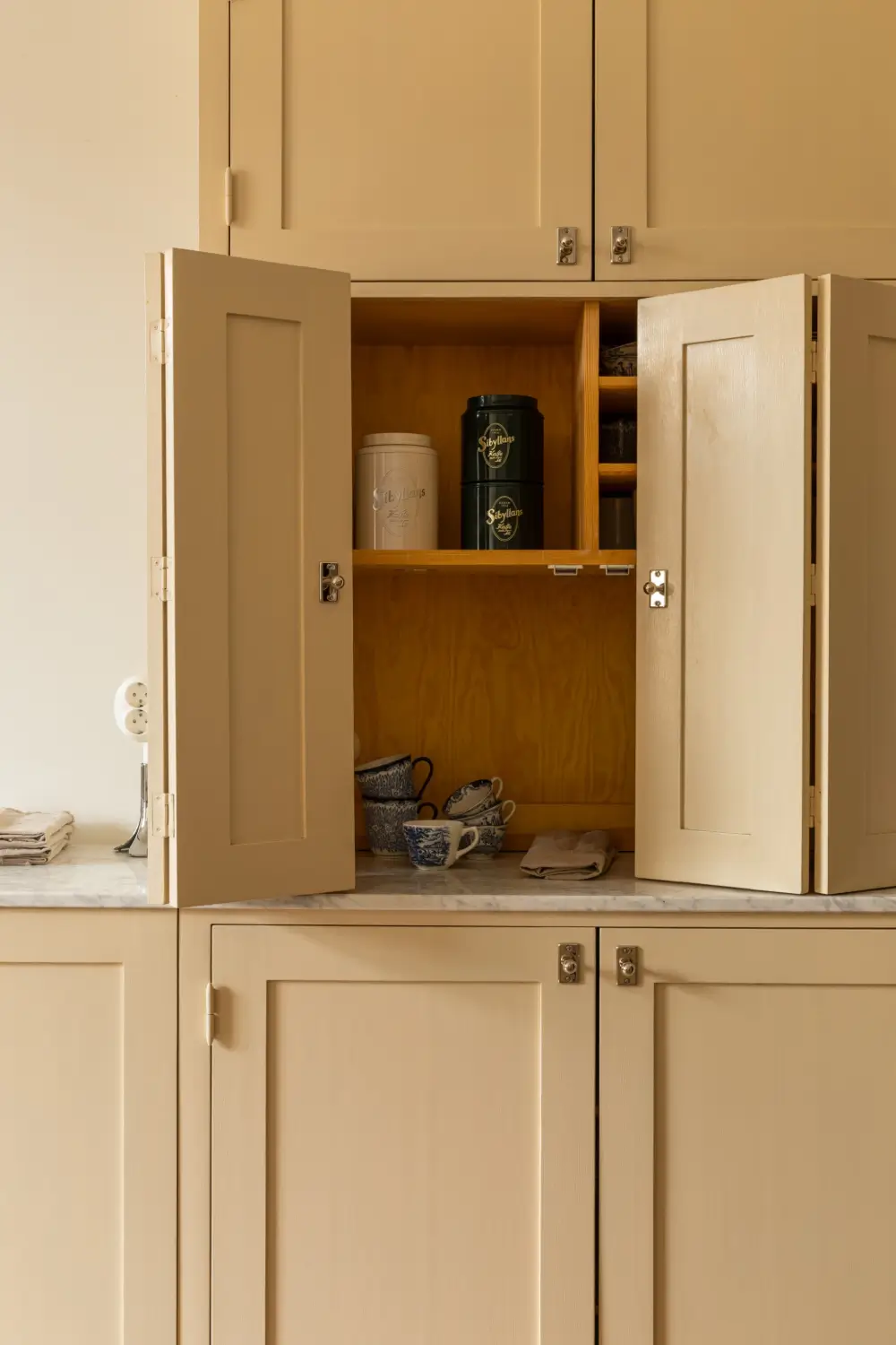 A Rich Burgundy Hall in a Stylishly Renovated Stockholm Apartment 19 butter-yellow-kitchen-period-character-stockholm-apartment-nordroom