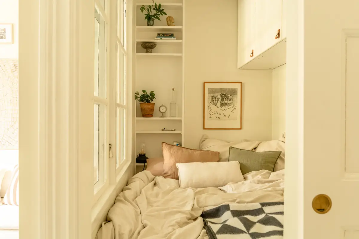 A Dividing Wall with Flea Market Windows Creates a Cozy Sleeping Niche in this Apartment 14 light-filled-turn-of-the-century-apartment-stockholm-nordroom