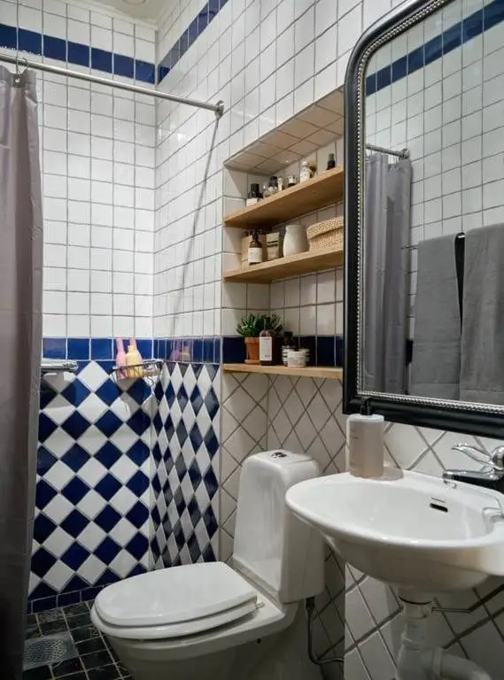 Before & After: A Colorful, Modern Update for a Late 19th-Century Apartment 45 small bathroom blue white tiles nordroom Before & After: A Colorful, Modern Update for a Late 19th-Century Apartment