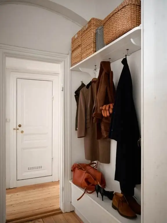 Before & After: A Colorful, Modern Update for a Late 19th-Century Apartment 46 white hall built in hat shoe rack nordroom Before & After: A Colorful, Modern Update for a Late 19th-Century Apartment