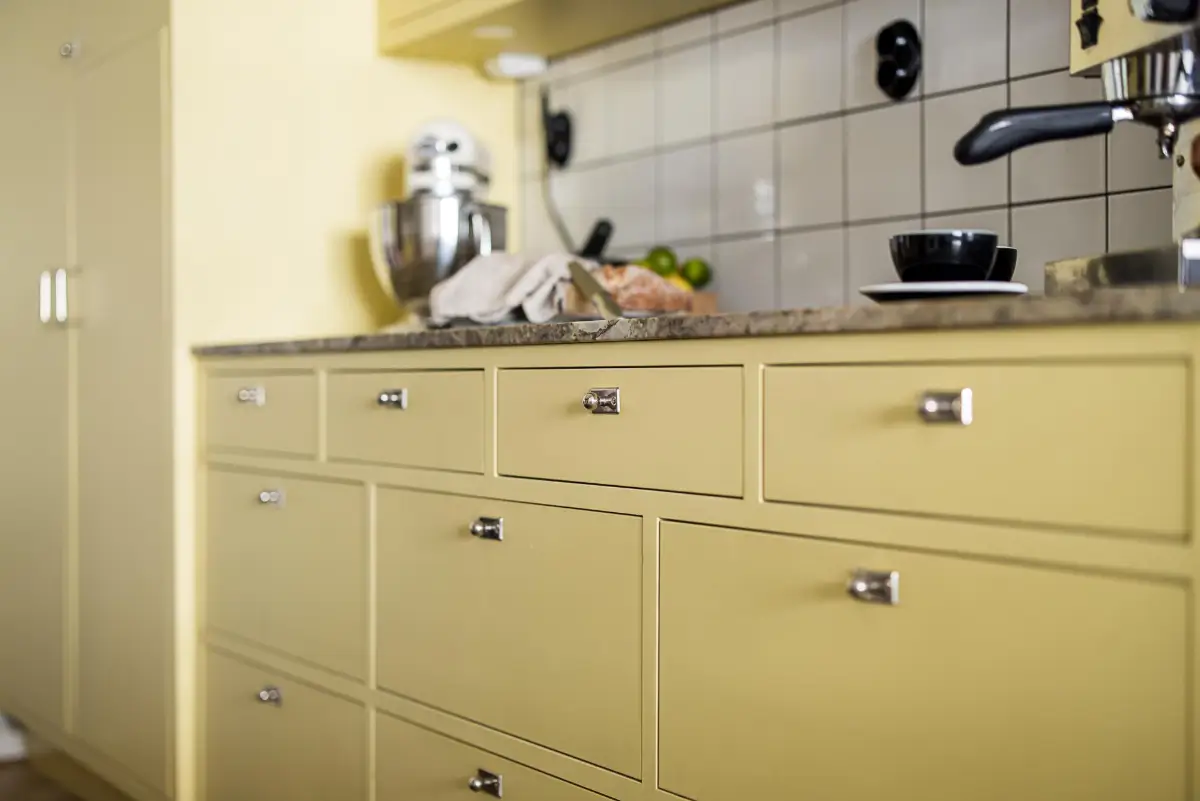 Original Features in a Colorful Midcentury Apartment in Sweden 12 yellow-kitchen-original-features-1940s-apartment-nordroom
