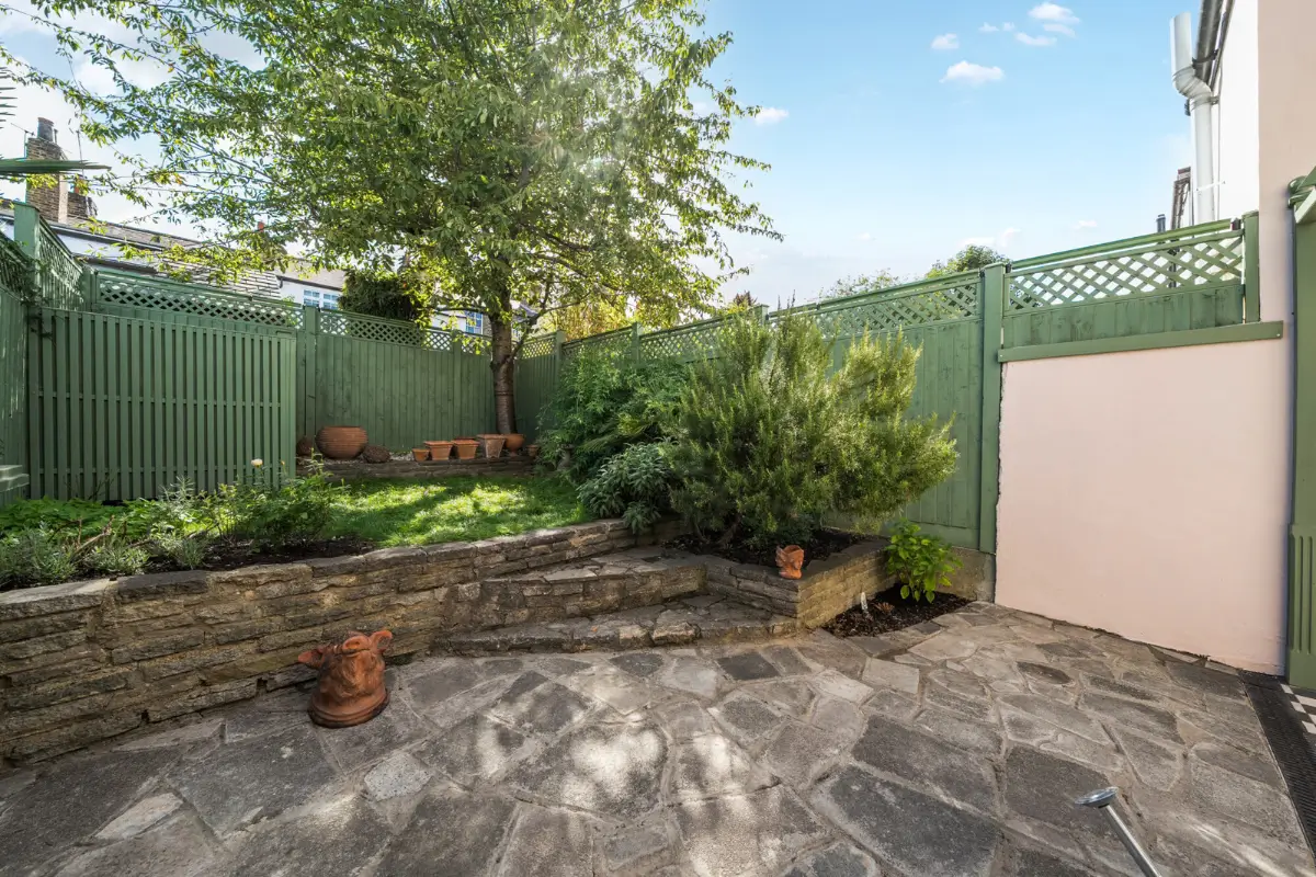 A London Family Home with a Pink deVOL Kitchen and Mint-Green Floorboards 18 garden-green-fencing