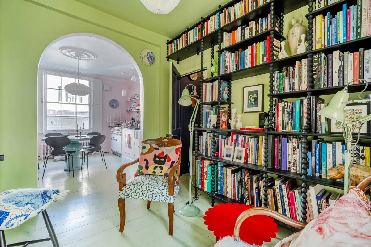 A London Family Home with a Pink deVOL Kitchen and Mint-Green Floorboards 2 open-plan-living-space-green-painted-floorboards-bookshelves