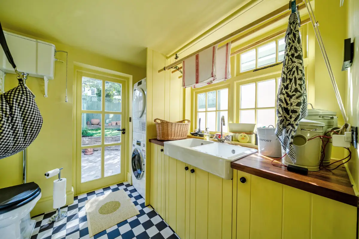 A London Family Home with a Pink deVOL Kitchen and Mint-Green Floorboards 6 yellow-laundry-room-checkered-floor